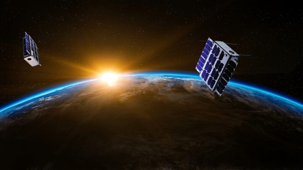 The Earth with two Sateliot nanosatellites orbiting above, symbolizing global coverage. IoT connectivity enables seamless communication across regions, bridging gaps through satellite technology.